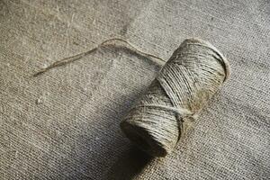 Skeins of thread on burlap. Yellow threads on coarse cloth. photo