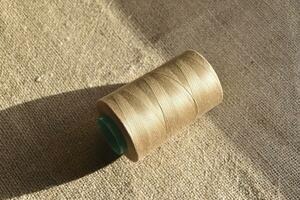 Skeins of thread on burlap. Yellow threads on coarse cloth. photo