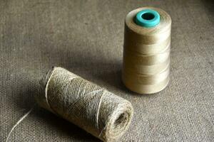 Skeins of thread on burlap. Yellow threads on coarse cloth. photo