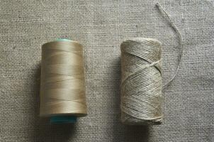 Skeins of thread on burlap. Yellow threads on coarse cloth. photo