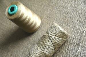 Skeins of thread on burlap. Yellow threads on coarse cloth. photo