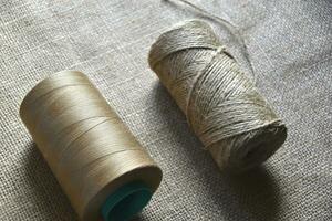 Skeins of thread on burlap. Yellow threads on coarse cloth. photo