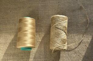 Skeins of thread on burlap. Yellow threads on coarse cloth. photo