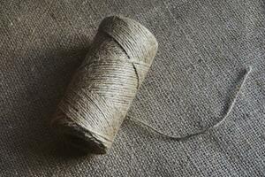 Skeins of thread on burlap. Yellow threads on coarse cloth. photo