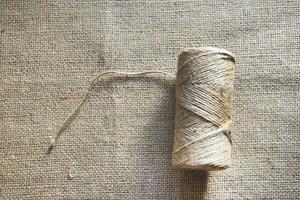 Skeins of thread on burlap. Yellow threads on coarse cloth. photo