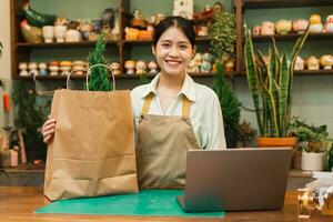 Portrait of Asian woman working in a plant shop photo