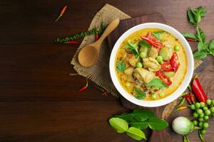 Chicken green curry Asian food, Beef green curry Thai food on a soup bowl with a mixture of herbs, vegetables and Thai red chilli spices. Top view. photo