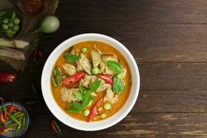 Chicken green curry Asian food, Beef green curry Thai food on a soup bowl with a mixture of herbs, vegetables and Thai red chilli spices. Top view. photo