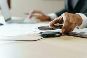 Charging mobile phone battery with wireless charging device in the table. Smartphone charging on a charging pad. Mobile phone near wireless charger Modern lifestyle technology concept photo