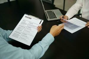 Examiner reading a resume during job interview at office Business and human resources concept. photo