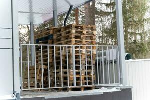 Stack of Wooden Pallets Arranged for Shipment at Store Unloading Area photo