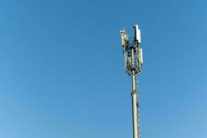 Telecommunications Tower Standing Tall Against Clear Blue Sky photo