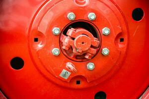 Close-up of a Massive Iron Tractor Wheel in Agricultural Field photo