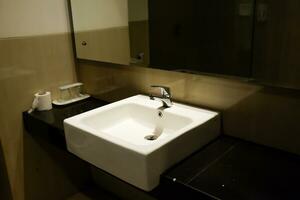 Bathroom sinks usually have a modern and functional design with mirrors photo