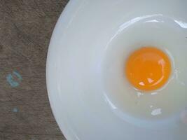 bowl of four egg yolks isolated on white background, top view photo