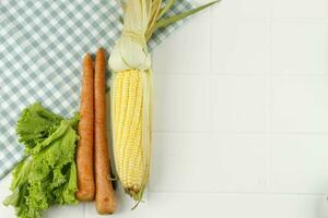 Corn, Carrot, and Lettuce on White Table photo