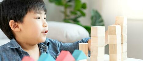 Happy Asian child playing and learning toy blocks. children are very happy and excited at home. child have a great time playing, activities, development, attention deficit hyperactivity disorder photo