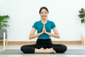 woman practicing meditate in condominium. Asian woman do exercises in morning. balance, recreation, relaxation, calm, good health, happy, relax, healthy lifestyle, reduce stress, peaceful, Attitude. photo