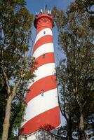red lighthouse in the country photo