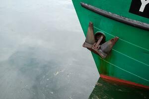 anchor on a green fishing boat photo