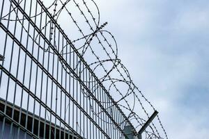 barbed wire fence against blue sky photo