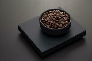 Roasted coffee beans on a black digital scale. photo