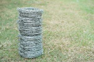 Rolls of barbed wire. Outdoor background. Concept, construction tool. Barbed wire is used for make fences , secure property ,make border to show the territory of area. photo