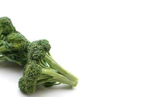 Fresh organic broccoli on white background. Concept, food ingredient. Healthy eating, source of vitamins, folate, fiber and molybdenum that can be cook for various food menu. photo