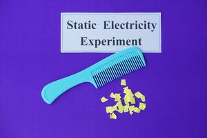 Comb and small pieces of paper. Equipment, prepared to do experiment about static electricity. Blue background. Concept, Science lesson, fun and easy experiment. Education. Teaching aids. photo
