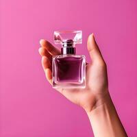 AI generated Hand Holding Elegant Perfume Bottle on Pink Background photo