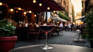 AI generated Generative AI, glass of red wine on wooden table with blur background with lights of street bar, cafe or restaurant photo