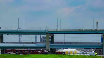 A timelapse of traffic jam at the downtown street and highway telephoto shot panning video