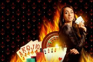 Smiling model in black dress showing two aces. Posing on colorful background with playing cards, roulette and chips. Poker, casino. Close-up photo