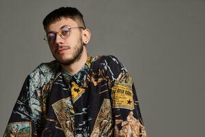 Close-up portrait of a funny guy posing in studio isolated on a gray background. photo