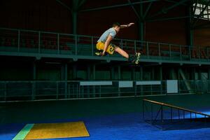 The man performs a trick. Jump. Indoor training photo