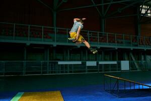 The man performs a trick. Jump. Indoor training photo