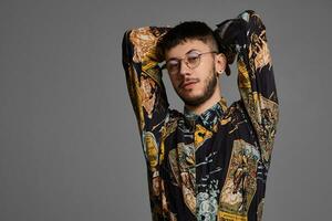 Close-up portrait of a funny guy posing in studio isolated on a gray background. photo