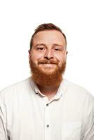 Portrait of a young, chubby, redheaded man in a white shirt making faces at the camera, isolated on a white background photo