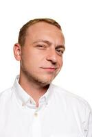 Handsome young blond man in a white shirt, isolated on a white background photo