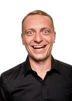 Handsome young blond man in a black shirt, isolated on a white background photo