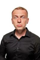 Handsome young blond man in a black shirt, isolated on a white background photo