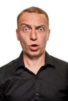 Handsome young blond man in a black shirt, isolated on a white background photo