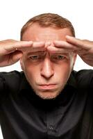 Handsome young blond man in a black shirt, isolated on a white background photo