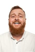 Portrait of a young, chubby, redheaded man in a white shirt making faces at the camera, isolated on a white background photo