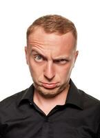 Handsome young blond man in a black shirt, isolated on a white background photo