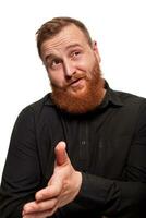 Portrait of a young, chubby, redheaded man in a black shirt making faces at the camera, isolated on a white background photo