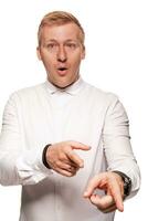 Imposing, young, blond man in a white shirt is grimacing while standing isolated on a white background photo