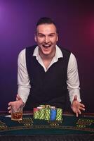 Wealthy man is playing poker with an excitement at a casino on black background. photo