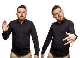 Brutal, attractive, bearded man poses in a black shirt, isolated on a white background photo