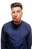 Attractive young man wearing blue shirt, isolated over a white background. photo